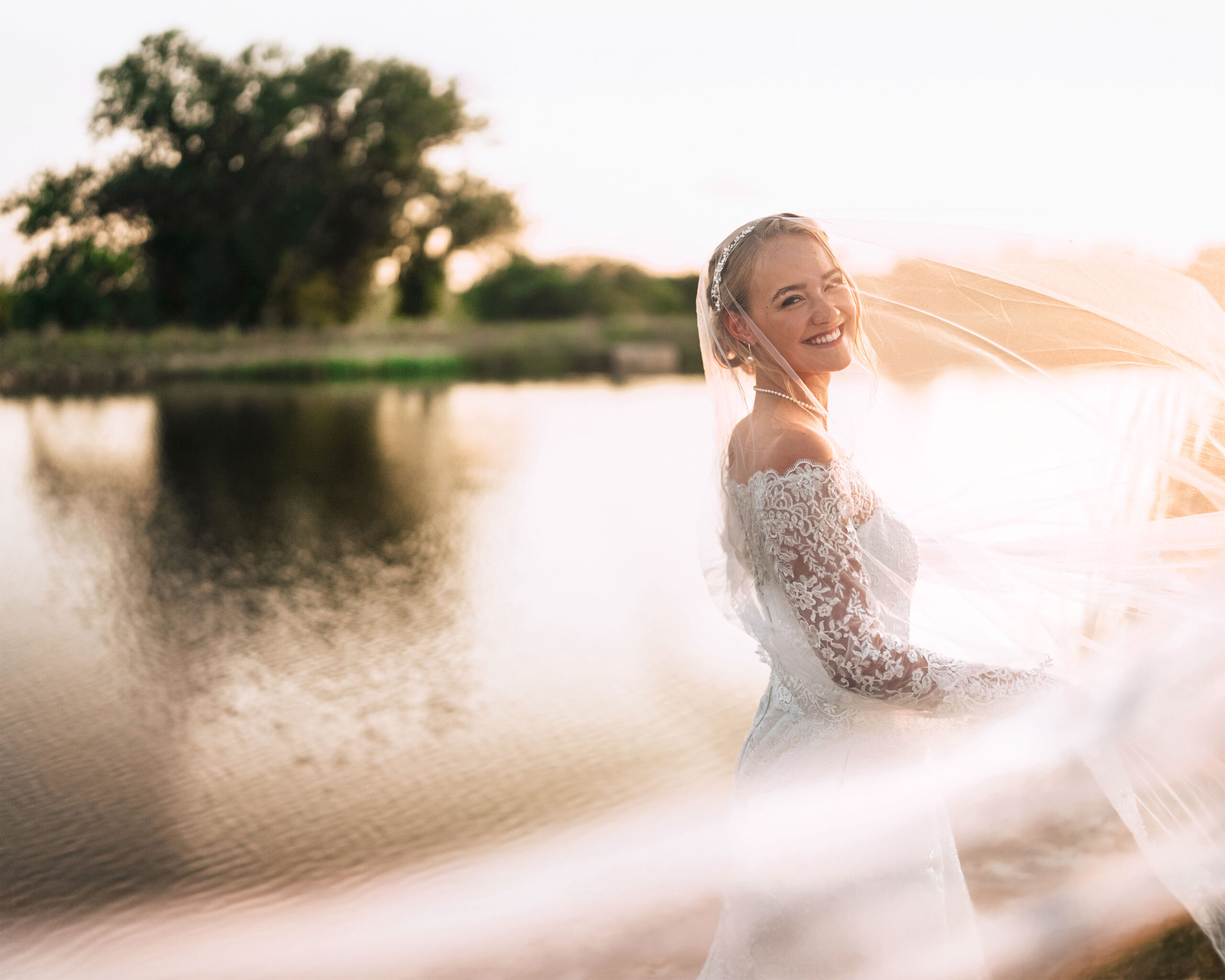 A bride posing for a Dallas WEdding photographer by a lake