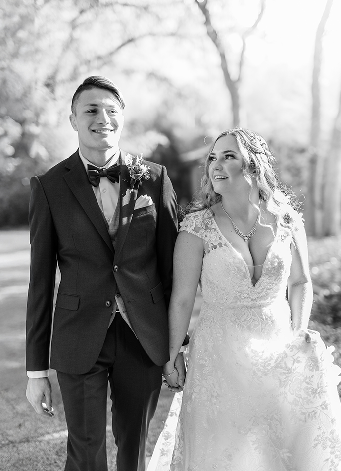 Bride and Groom walking and smiling at each other