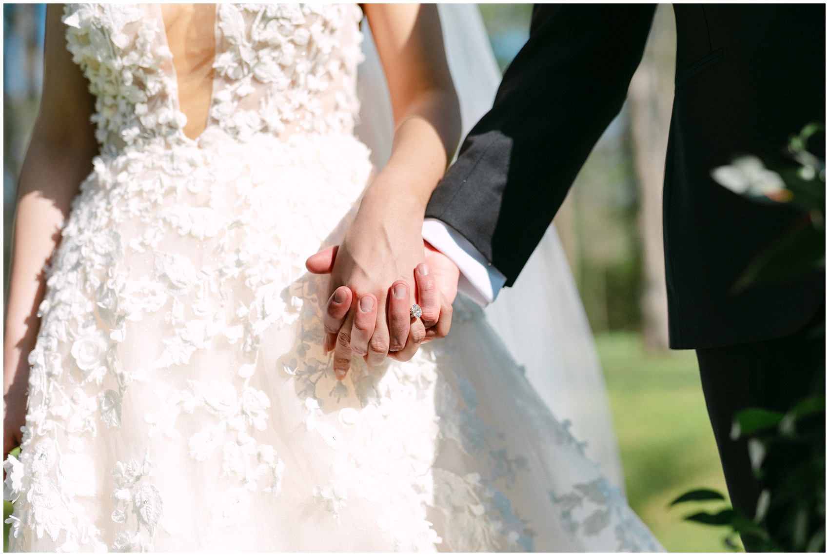 Newlyweds hold hands and walk in a garden in the sun at their Chandon Arbors wedding