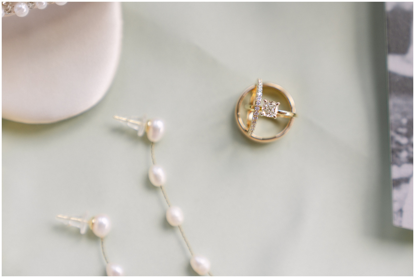 Details of wedding rings and pearl earrings on a table at a Chandon Arbors wedding