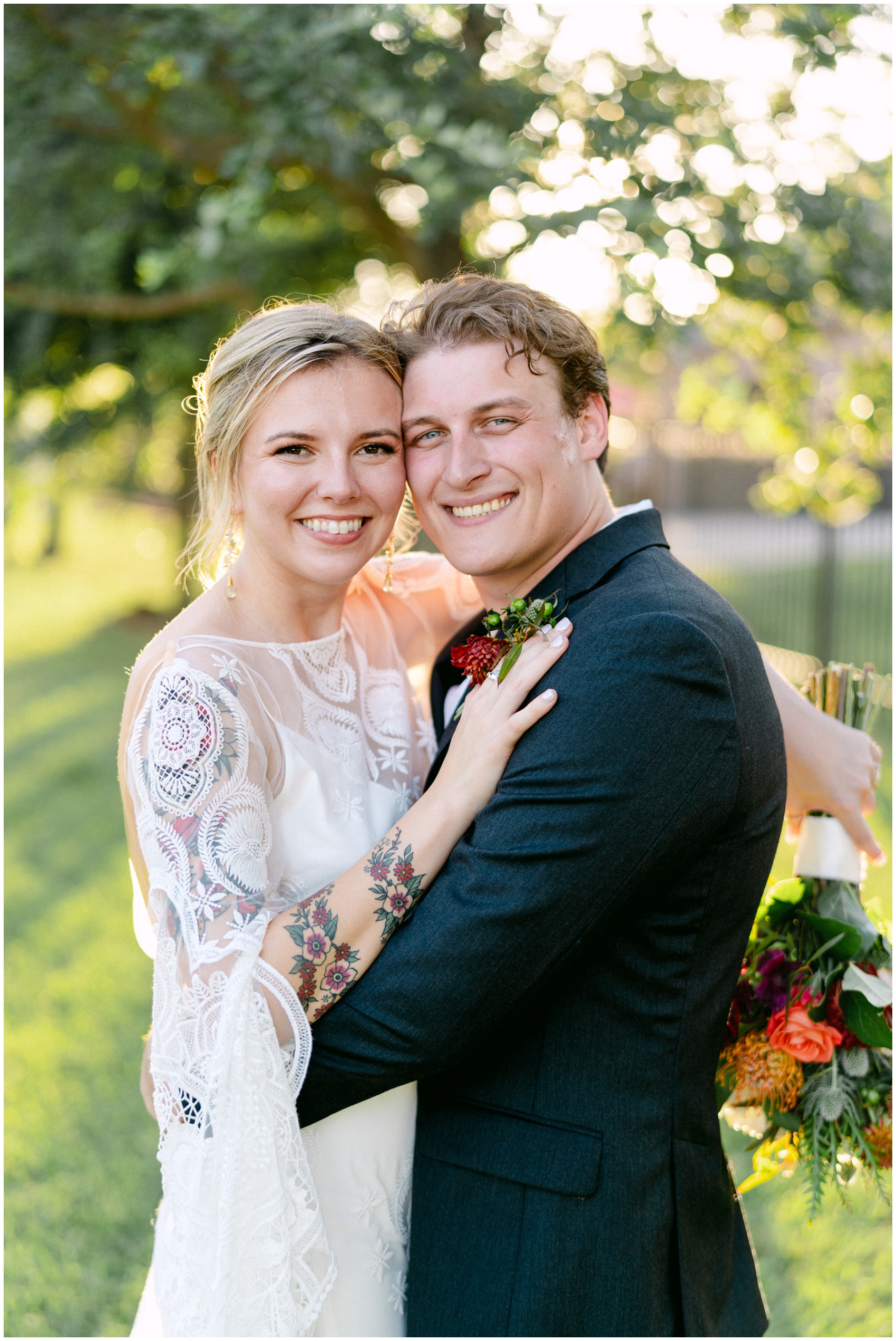 Newlyweds smile cheek to cheek in a lawn at sunset during their Firefly Gardens Wedding