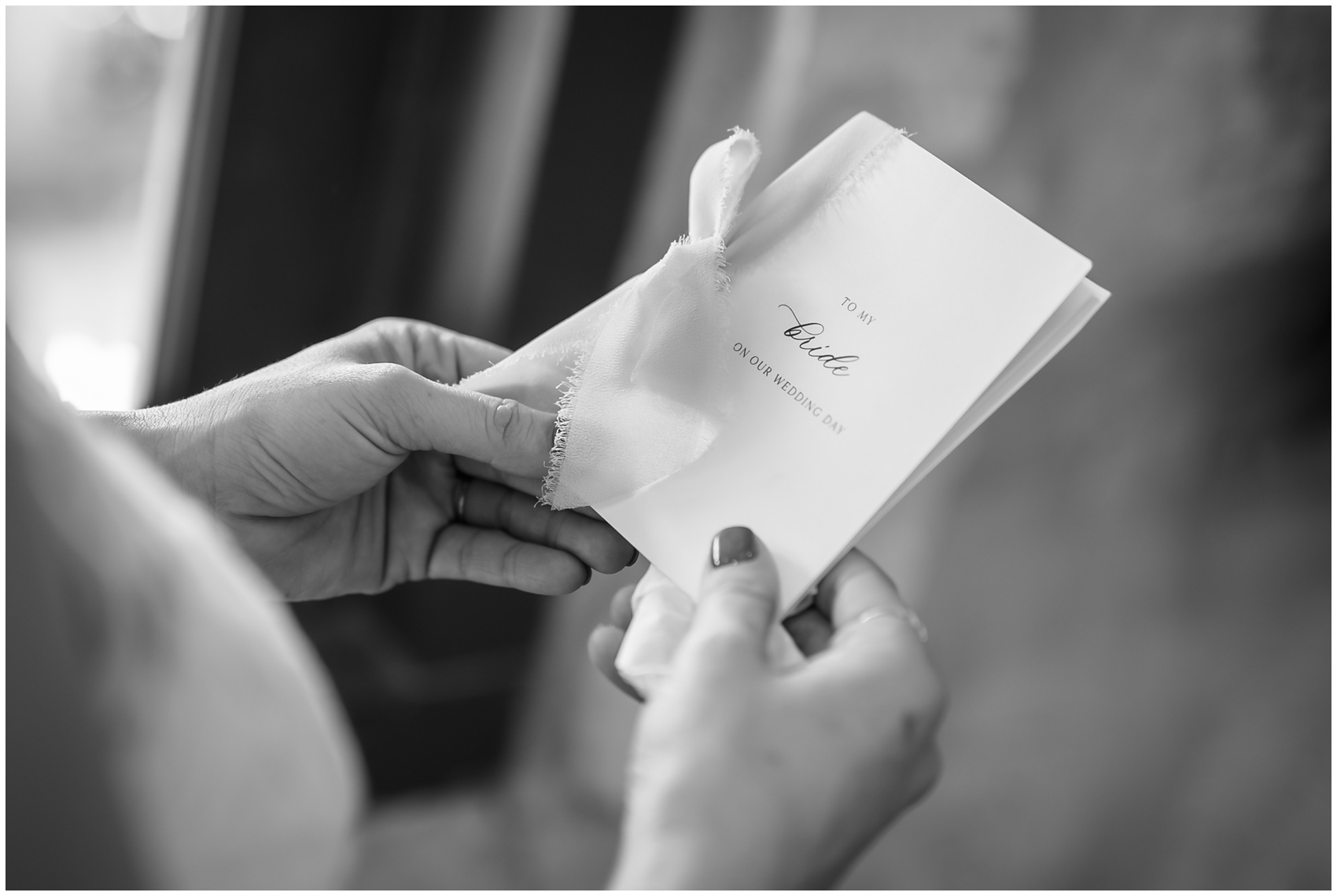 Details of a bride looking down at her note from her groom