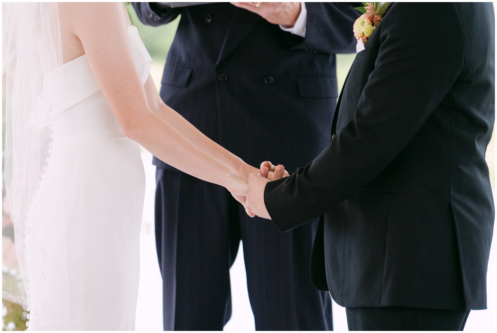 Newlyweds hold hands at the altar in front of their officiant at Lazy S Hacienda