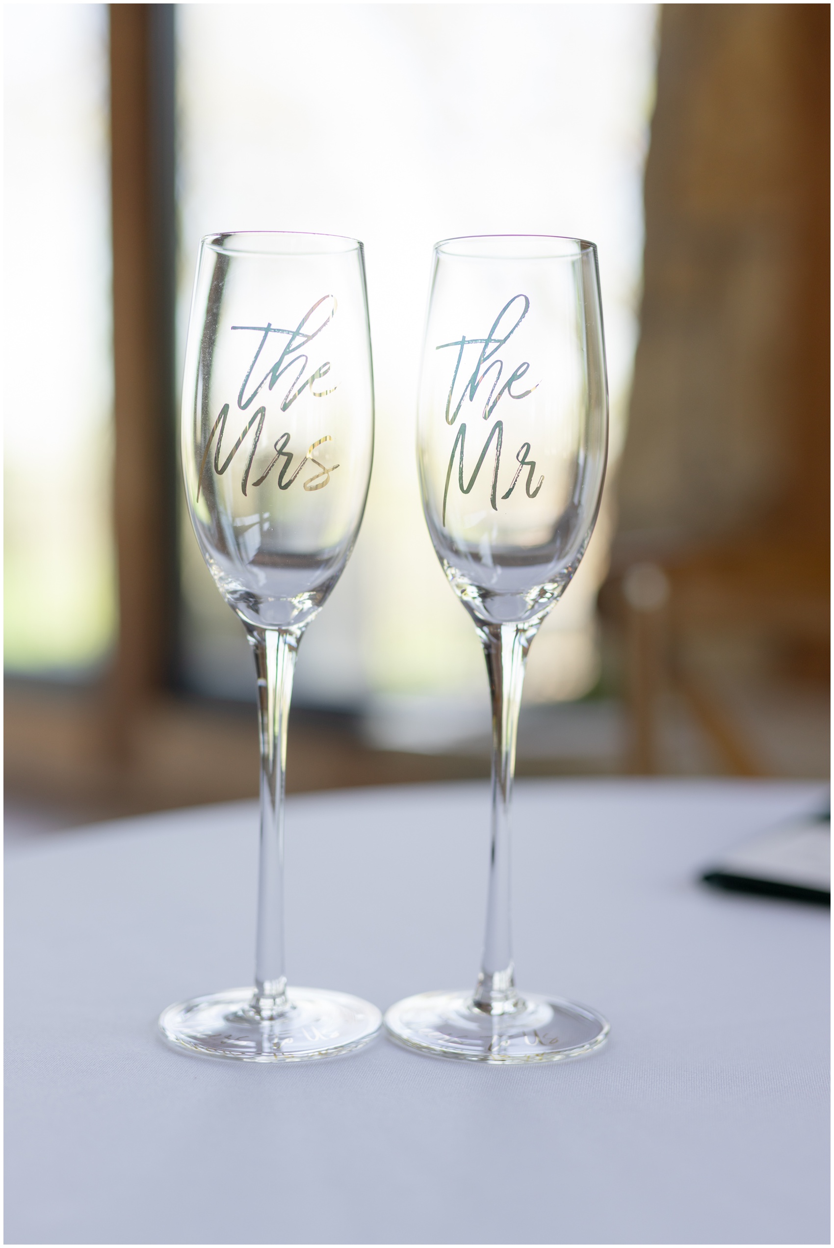 Details of Mr and Mrs champagne glasses on a table at The Mason Dallas Wedding Venue