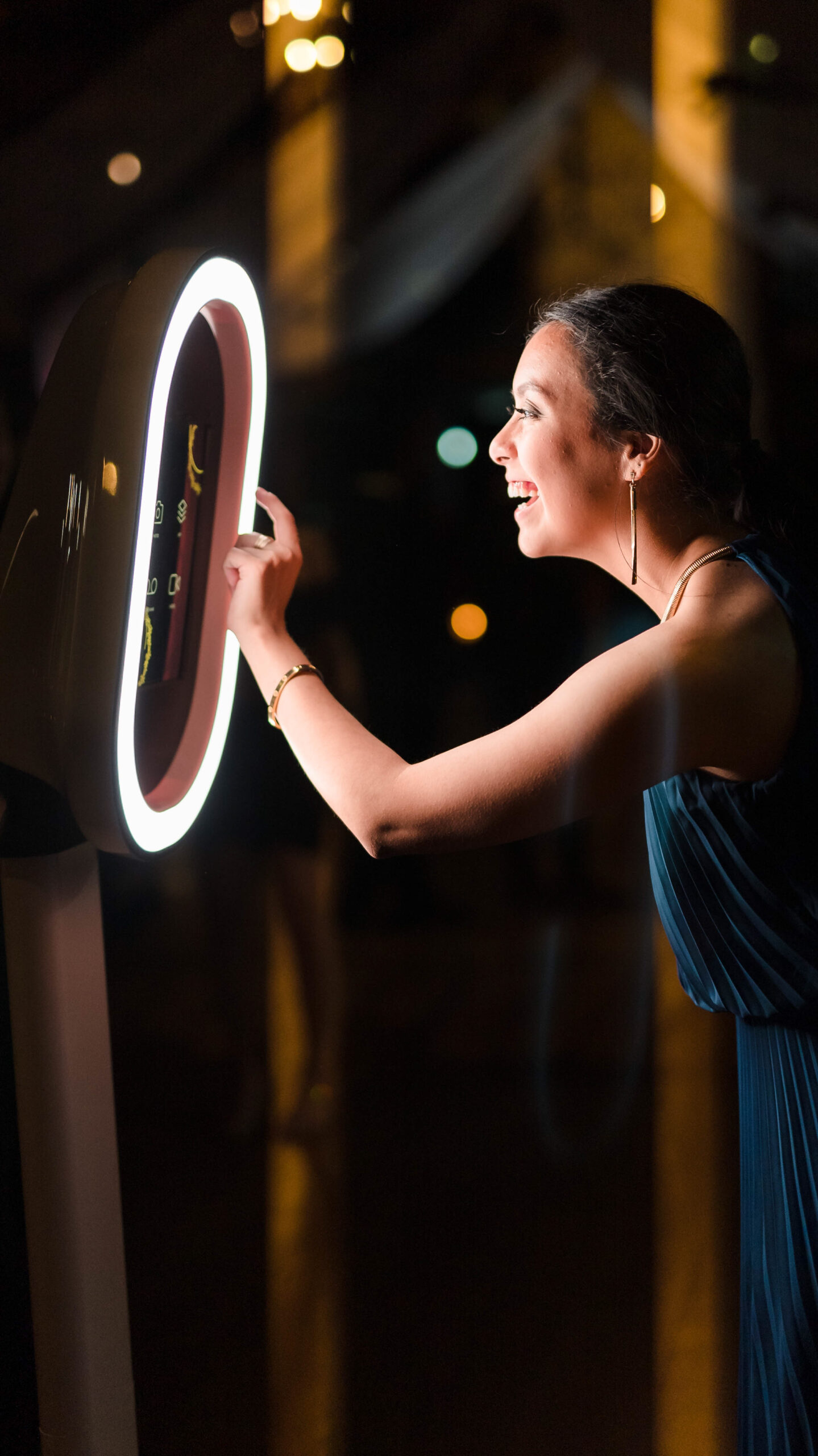 A young girl playing with a DFW Photo Booth at a wedding