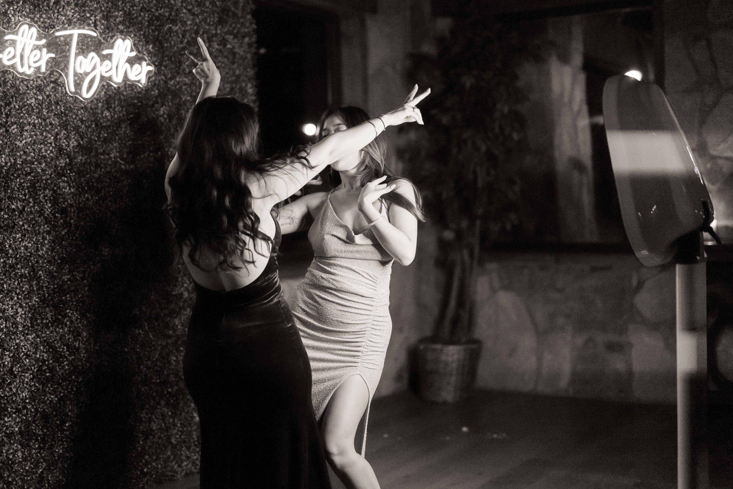 Young girls having fun and playing with a DFW Photo Booth at a wedding