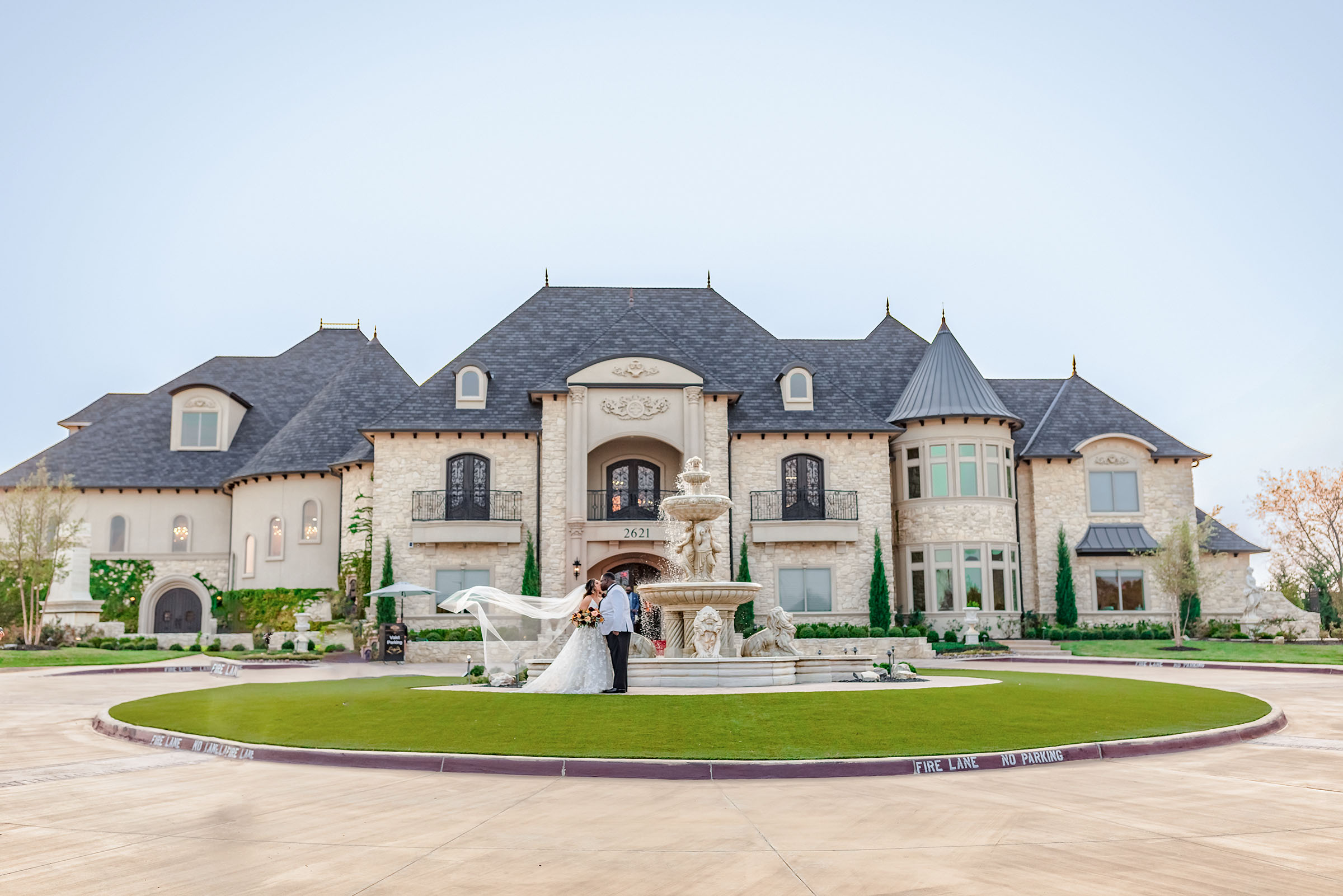 Luxury Dallas wedding couple photographed in front of an elegant wedding venue