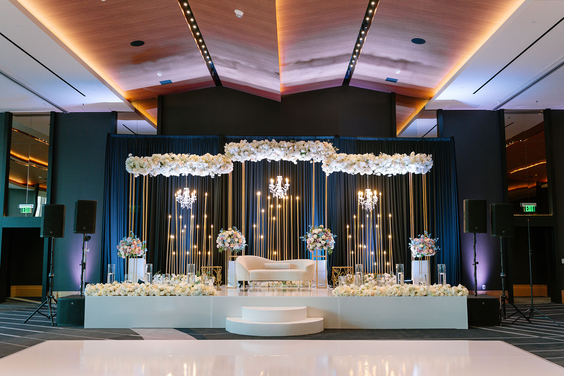 Luxury wedding reception design with florals and candlelit stage in Dallas-Fort Worth